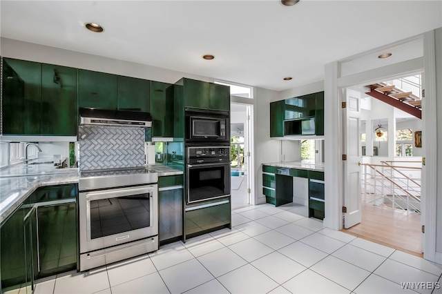 52 Hidden Pines Ct, Amherst, NY 14051 - kitchen with green cabinetry, black appliances, under cabinet range hood, light stone countertops, and light tile patterned floors