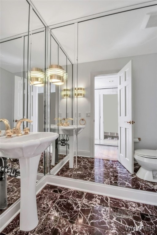 52 Hidden Pines Ct, Amherst, NY 14051 - bathroom featuring marble look tile flooring and toilet