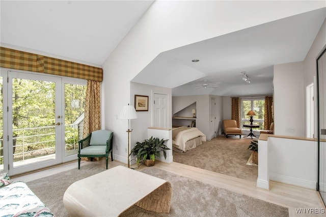 52 Hidden Pines Ct, Amherst, NY 14051 - carpeted living area featuring lofted ceiling, ceiling fan, baseboards, and wood finished floors