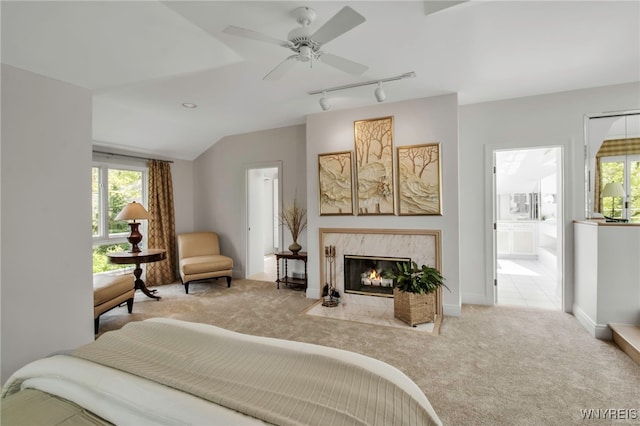 52 Hidden Pines Ct, Amherst, NY 14051 - carpeted bedroom with multiple windows, track lighting, a high end fireplace, ensuite bath, and lofted ceiling