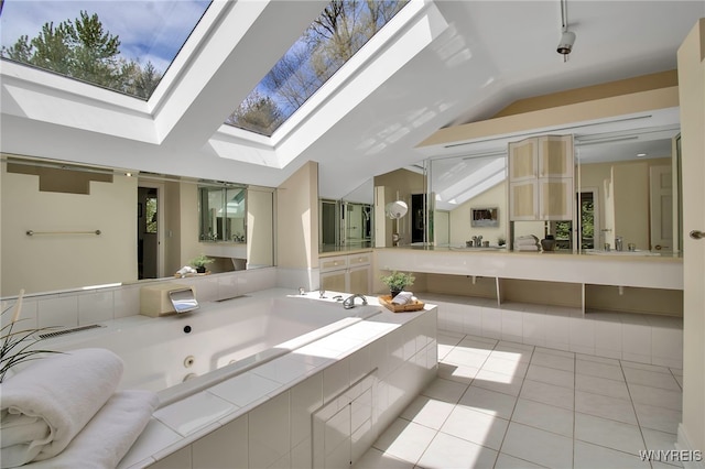 52 Hidden Pines Ct, Amherst, NY 14051 - full bath featuring vaulted ceiling, a skylight, tile patterned flooring, a whirlpool tub, and double vanity