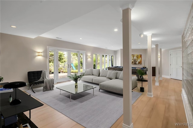52 Hidden Pines Ct, Amherst, NY 14051 - living room with decorative columns, light wood-type flooring, and french doors