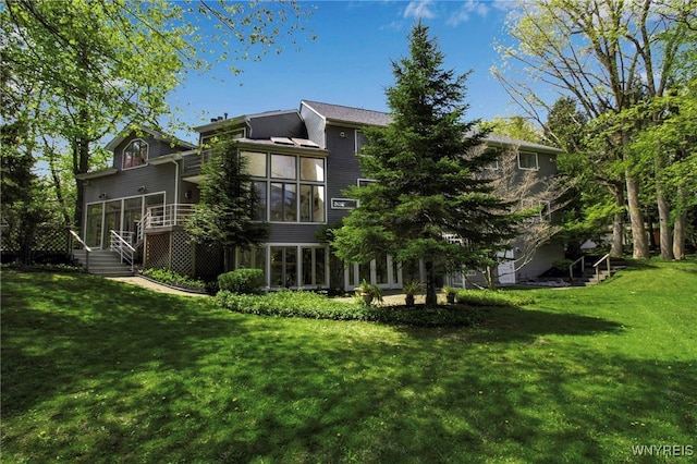 52 Hidden Pines Ct, Amherst, NY 14051 - back of property featuring a sunroom, a yard, and a deck