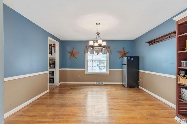 106 Hillside Way, Camillus, NY 13031 - unfurnished dining area featuring a chandelier, wood finished floors, and baseboards