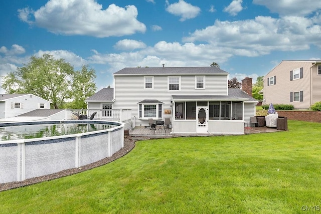 106 Hillside Way, Camillus, NY 13031 - back of property featuring a sunroom, a yard, a deck, and a shingled roof