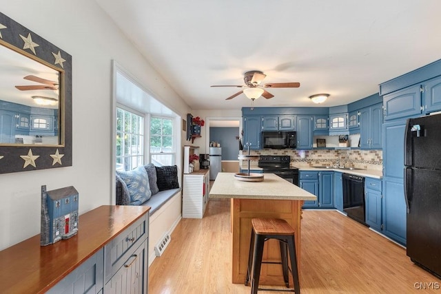 106 Hillside Way, Camillus, NY 13031 - kitchen with black appliances, a ceiling fan, blue cabinetry, decorative backsplash, and a sink