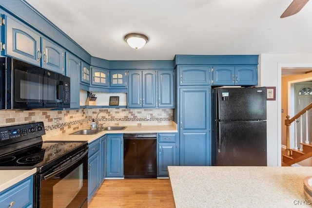 106 Hillside Way, Camillus, NY 13031 - kitchen featuring black appliances, blue cabinets, light countertops, and backsplash