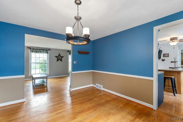 106 Hillside Way, Camillus, NY 13031 - spare room with a chandelier, wood finished floors, baseboards, and ceiling fan