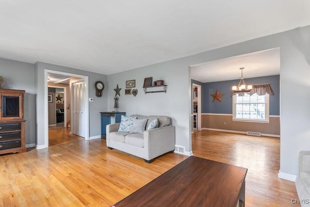 106 Hillside Way, Camillus, NY 13031 - living room with light wood-style flooring, a chandelier, and baseboards