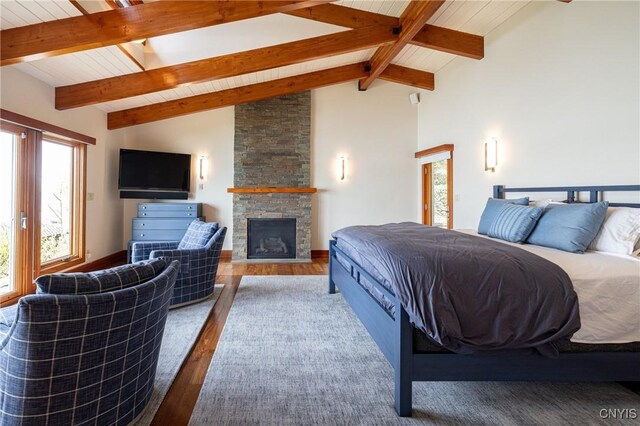 9182 S Rhodes Rd, Lodi, NY 14860 - bedroom with wood finished floors, a stone fireplace, and wood ceiling