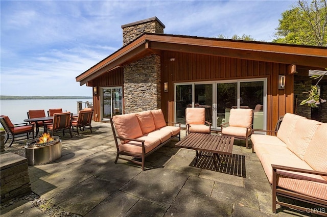9182 S Rhodes Rd, Lodi, NY 14860 - view of patio featuring an outdoor living space with a fire pit and a water view