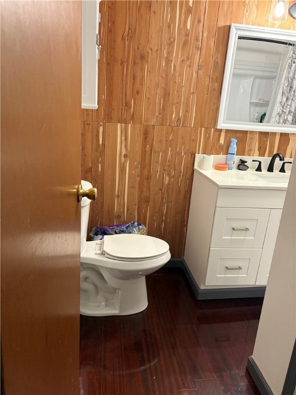 399 Electric Ave, Rochester, NY 14613 - bathroom featuring vanity, wood finished floors, wood walls, and toilet