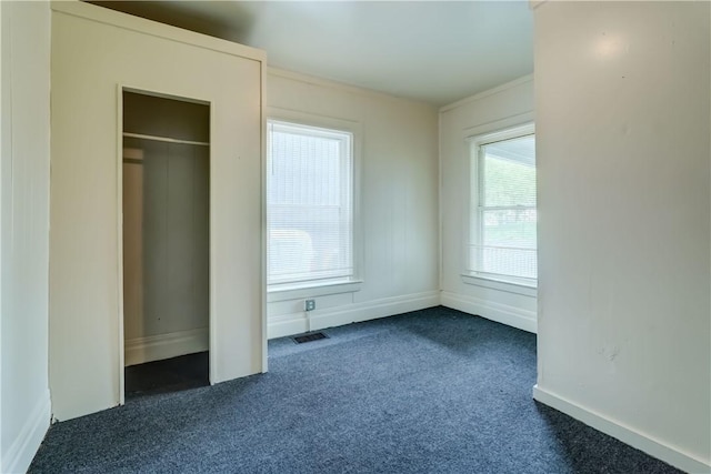 475 Sherman St, Rochester, NY 14606 - unfurnished bedroom with dark colored carpet and baseboards