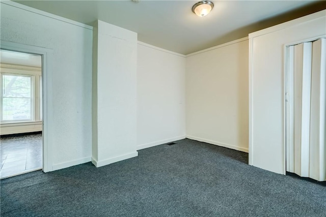 475 Sherman St, Rochester, NY 14606 - empty room featuring dark carpet and baseboards