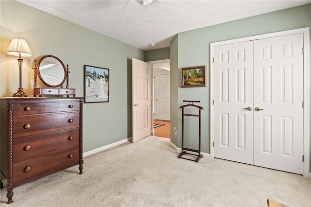 4166 Angela Way, Gorham, NY 14424 - bedroom featuring light colored carpet, a closet, baseboards, a ceiling fan, and a textured ceiling