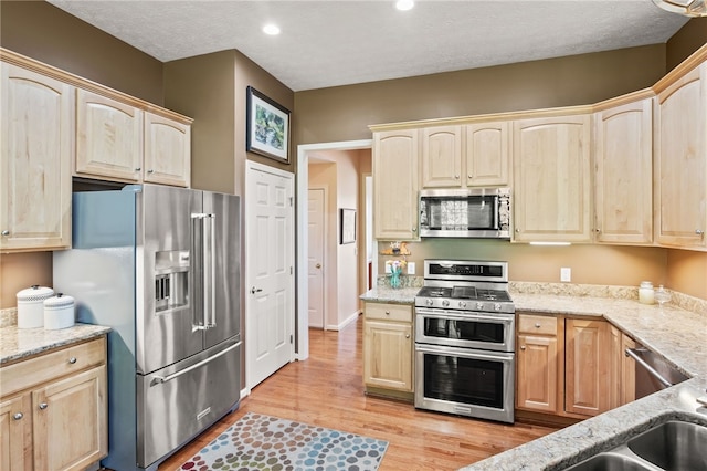 4166 Angela Way, Gorham, NY 14424 - kitchen featuring appliances with stainless steel finishes, light brown cabinetry, light stone counters, and recessed lighting
