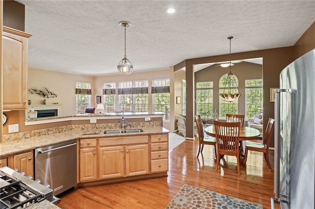 4166 Angela Way, Gorham, NY 14424 - kitchen featuring appliances with stainless steel finishes, a sink, a textured ceiling, light wood-style floors, and light brown cabinetry