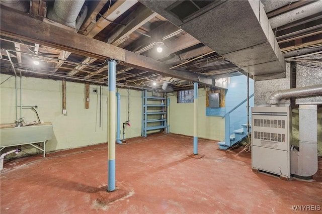 2452 Niagara Ave, Niagara Falls, NY 14305 - unfinished below grade area with electric panel, a sink, stairs, and heating unit