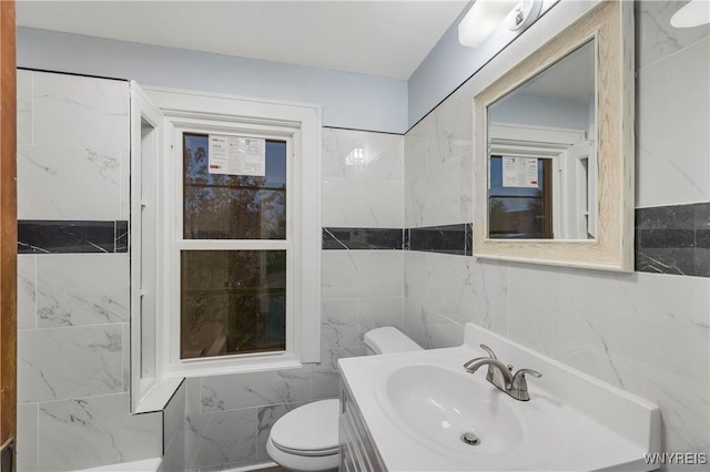 2452 Niagara Ave, Niagara Falls, NY 14305 - bathroom with toilet, vanity, and tile walls