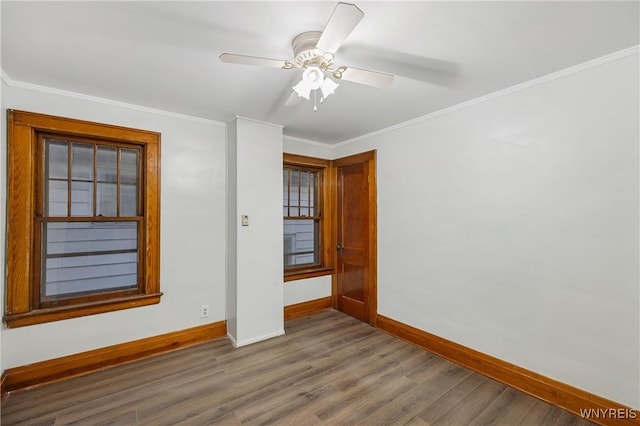 2452 Niagara Ave, Niagara Falls, NY 14305 - spare room featuring baseboards, dark wood-type flooring, crown molding, and a ceiling fan