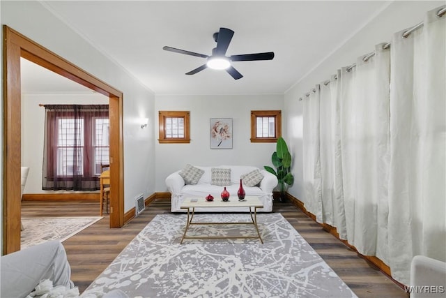 2452 Niagara Ave, Niagara Falls, NY 14305 - living room featuring ceiling fan, baseboards, dark wood finished floors, and ornamental molding