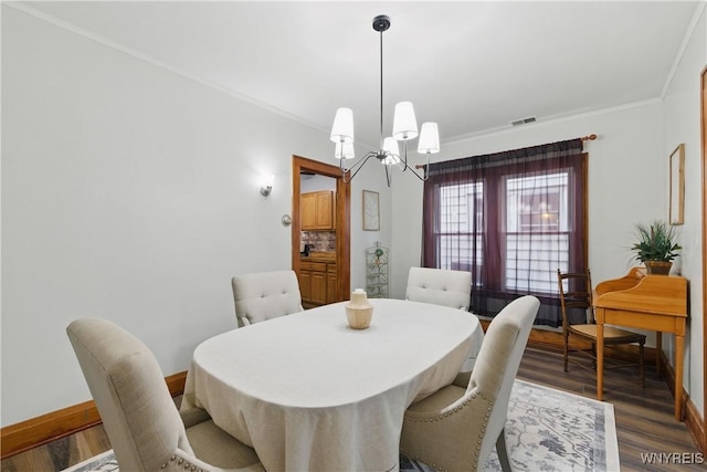 2452 Niagara Ave, Niagara Falls, NY 14305 - dining room featuring a chandelier, wood finished floors, baseboards, and ornamental molding