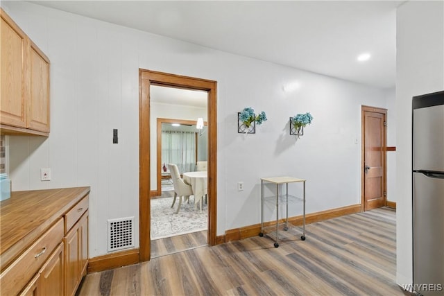 2452 Niagara Ave, Niagara Falls, NY 14305 - kitchen with freestanding refrigerator, wood finished floors, baseboards, and light countertops