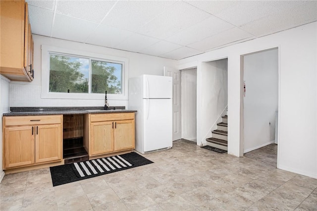 189 5th St, Rochester, NY 14605 - kitchen with freestanding refrigerator, a sink, a drop ceiling, dark countertops, and decorative backsplash