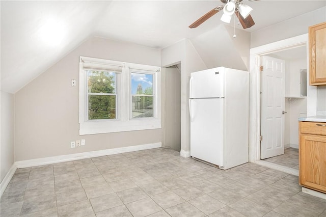 189 5th St, Rochester, NY 14605 - kitchen featuring freestanding refrigerator, ceiling fan, vaulted ceiling, light countertops, and light tile patterned floors