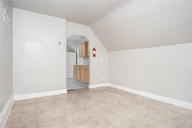 189 5th St, Rochester, NY 14605 - bonus room featuring lofted ceiling, arched walkways, and baseboards