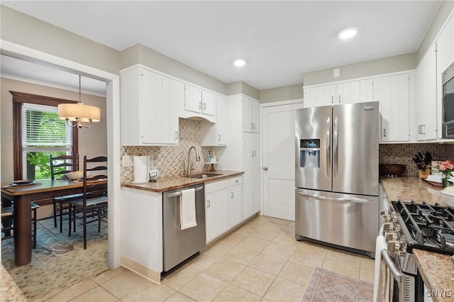 34-36 Hamilton Ave, Auburn, NY 13021 - kitchen with appliances with stainless steel finishes, a sink, tasteful backsplash, and light tile patterned flooring