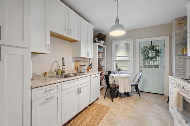 34-36 Hamilton Ave, Auburn, NY 13021 - kitchen featuring a sink, white appliances, light countertops, white cabinets, and pendant lighting