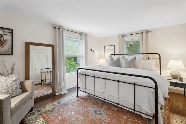34-36 Hamilton Ave, Auburn, NY 13021 - bedroom with wood finished floors, multiple windows, and baseboards
