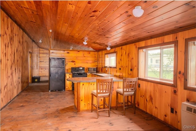 793 County Highway 19, Plainfield, NY 13491 - kitchen featuring black appliances, wooden walls, a sink, a peninsula, and wooden ceiling