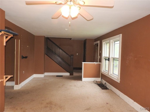 5 Evergreen St, Cortland, NY 13045 - unfurnished living room with stairway, carpet flooring, baseboards, and a ceiling fan