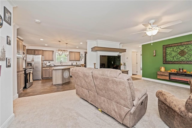 3854 Tari Ln, Murray, NY 14470 - living room featuring recessed lighting, a ceiling fan, crown molding, light colored carpet, and a chandelier