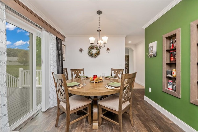 3854 Tari Ln, Murray, NY 14470 - dining room featuring ornamental molding, a chandelier, dark wood-type flooring, baseboards, and built in features