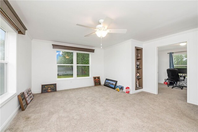 3854 Tari Ln, Murray, NY 14470 - unfurnished living room featuring ornamental molding, carpet flooring, a desk, ceiling fan, and built in shelves