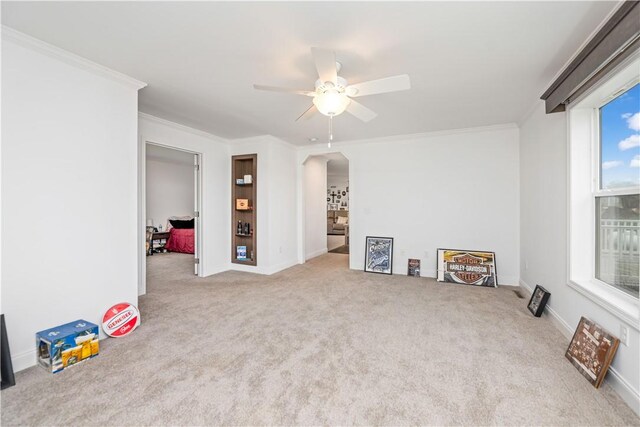 3854 Tari Ln, Murray, NY 14470 - empty room featuring arched walkways, a ceiling fan, carpet flooring, ornamental molding, and baseboards