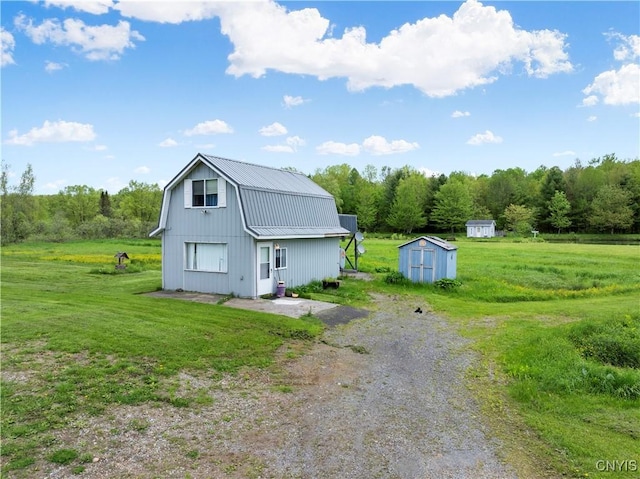 9748-9736 Podunk Rd, Lee, NY 13363 - view of home's exterior with a gambrel roof, a yard, and driveway