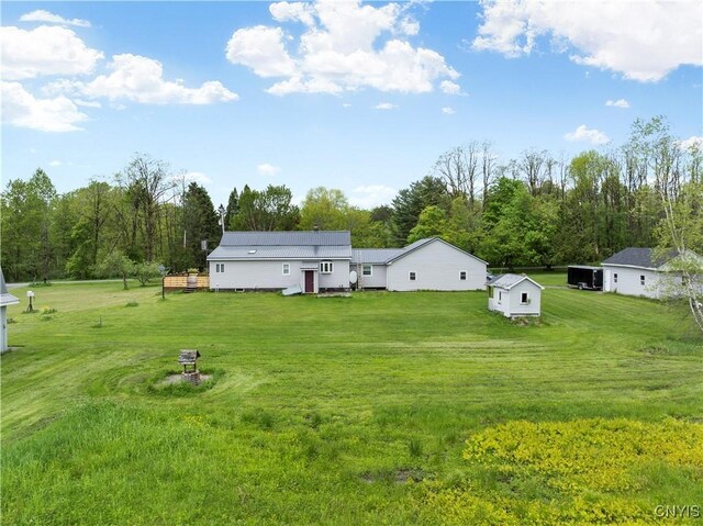 9748-9736 Podunk Rd, Lee, NY 13363 - rear view of property featuring a lawn, a wooden deck, and metal roof