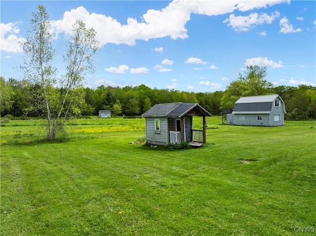 9748-9736 Podunk Rd, Lee, NY 13363 - view of grassy yard featuring an outdoor structure and a wooded view