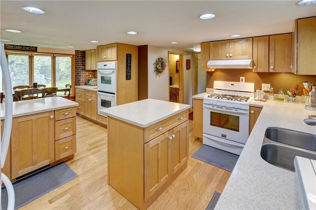 161 Bell Hill Rd, New Lisbon, NY 13342 - kitchen featuring white appliances, under cabinet range hood, a kitchen island, light countertops, and a sink