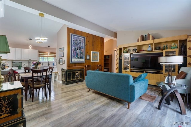 454 Kenwood Dr, Lewiston, NY 14092 - living room with light wood-style flooring and wooden walls
