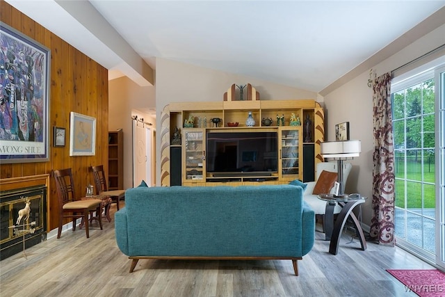 454 Kenwood Dr, Lewiston, NY 14092 - living area with wooden walls, vaulted ceiling, and wood finished floors