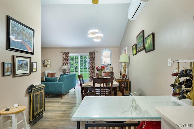 454 Kenwood Dr, Lewiston, NY 14092 - dining room with an AC wall unit, lofted ceiling, wood finished floors, and a chandelier