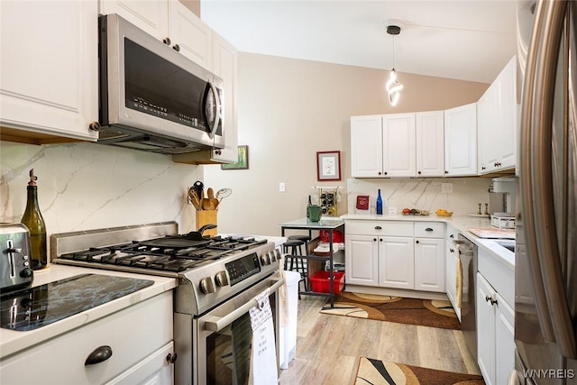 454 Kenwood Dr, Lewiston, NY 14092 - kitchen featuring stainless steel appliances, light wood finished floors, white cabinetry, backsplash, and light countertops