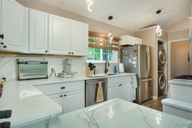 454 Kenwood Dr, Lewiston, NY 14092 - kitchen with appliances with stainless steel finishes, stacked washer / drying machine, white cabinets, light stone countertops, and pendant lighting