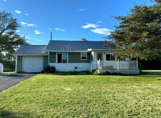 38857 State Route 12e, Clayton, NY 13624 - ranch-style home featuring an attached garage, driveway, a front lawn, and metal roof