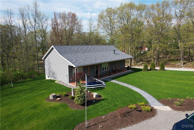 26633 Kring Point Rd, Alexandria, NY 13679 - view of front of home with a front lawn, a porch, and a shingled roof